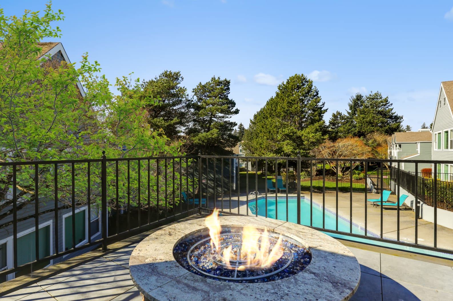 Outdoor fire pit looking over the pool