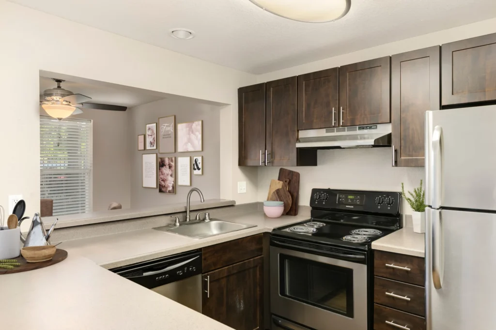 Kitchen with stainless steel appliances and bar seating at Meadows at Cascade Park apartments in Vancouver