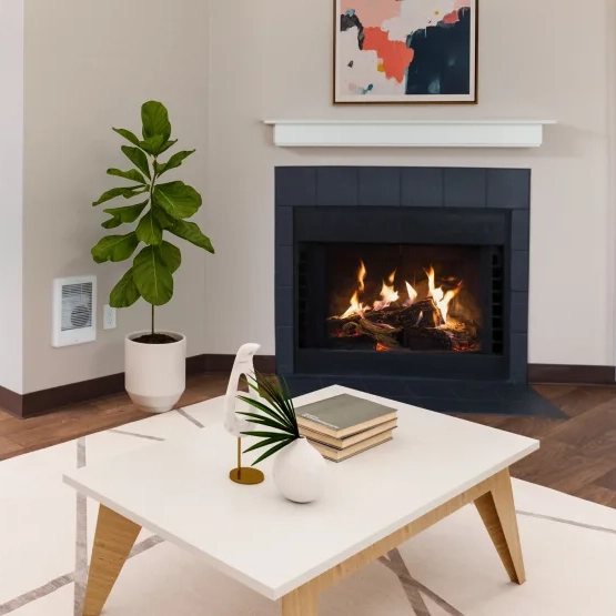 Living room with a fireplace and large windows at Meadows at Cascade Park apartments in Vancouver